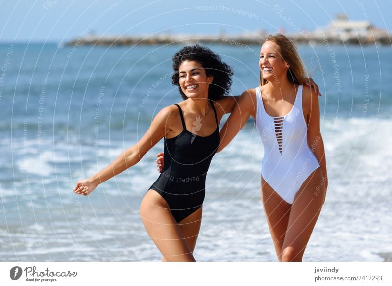 Two young women in swimwear on a tropical beach. Lifestyle Joy Happy Beautiful Hair and hairstyles Leisure and hobbies Vacation & Travel Tourism Summer Beach