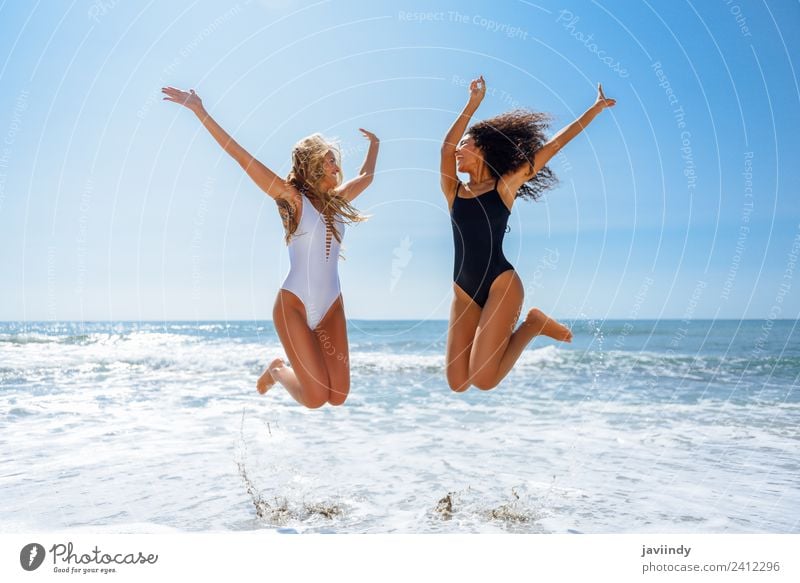 Two women in swimwear jumping on a tropical beach Joy Vacation & Travel Tourism Summer Beach Feminine Young woman Youth (Young adults) Woman Adults Friendship
