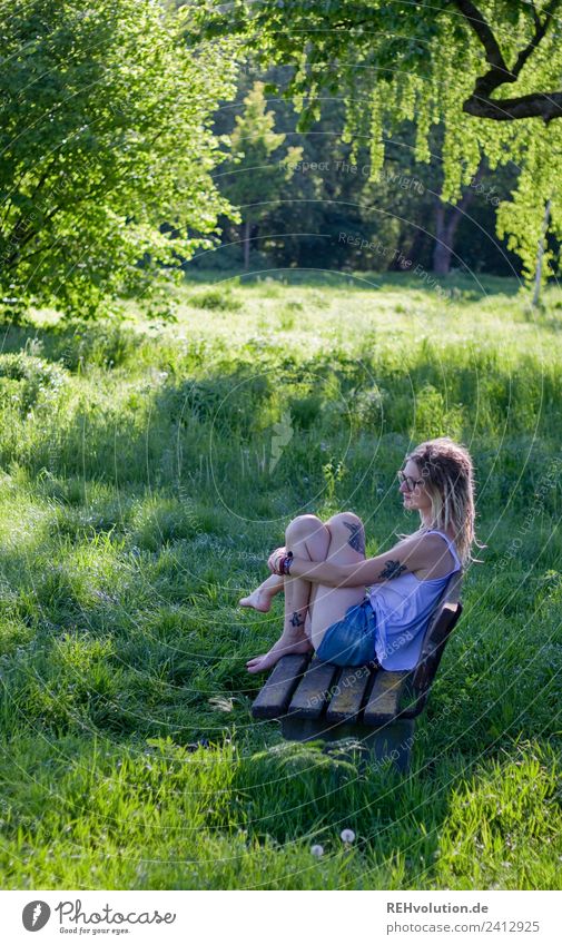 Jule Young woman with dreads is sitting on a bench in the green. Lifestyle Style Happy Harmonious Well-being Contentment Relaxation Calm Leisure and hobbies