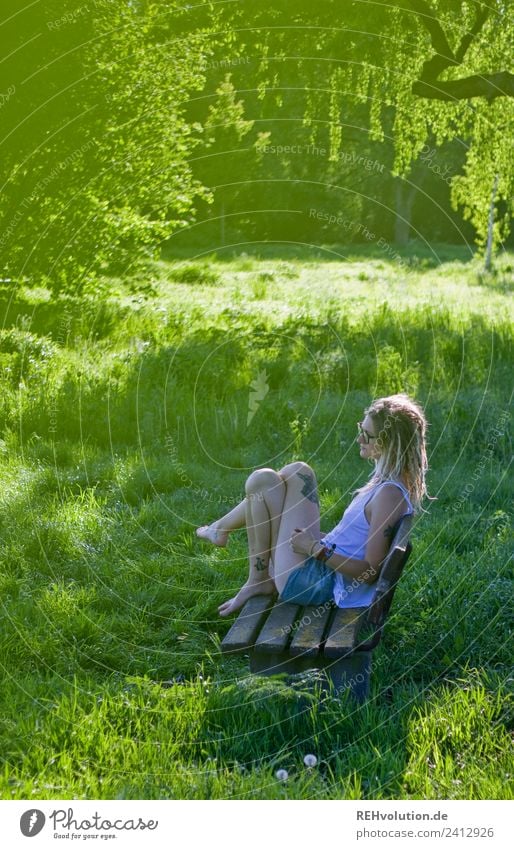 Jule Young woman with dreads is sitting on a bench in the green. Lifestyle Well-being Contentment Relaxation Calm Leisure and hobbies Human being Feminine