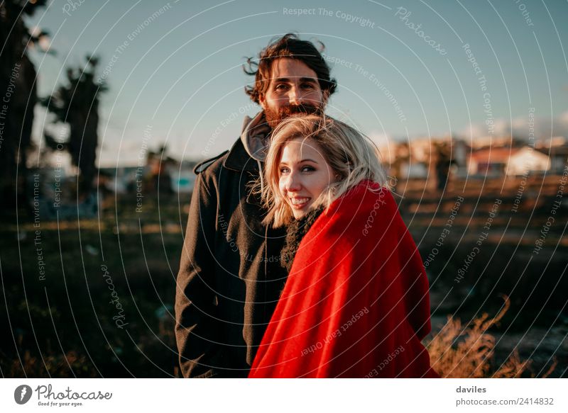 Blonde woman and bearded man having fun outdoors at sunset. Lifestyle Joy Playing Human being Young man Youth (Young adults) Couple 1 18 - 30 years Adults Wind