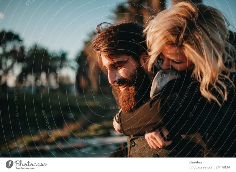 Cool hipster couple embraced and having fun while smiling happy outdoors. Lifestyle Joy Playing Woman Adults Man Couple 2 Human being Blonde Beard Smiling