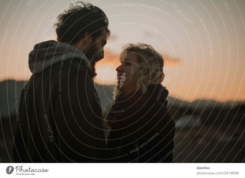 Blonde girl smiling and looking to her boyfriend at dusk Lifestyle Joy Sun Human being Young woman Youth (Young adults) Young man Couple Partner 2 18 - 30 years