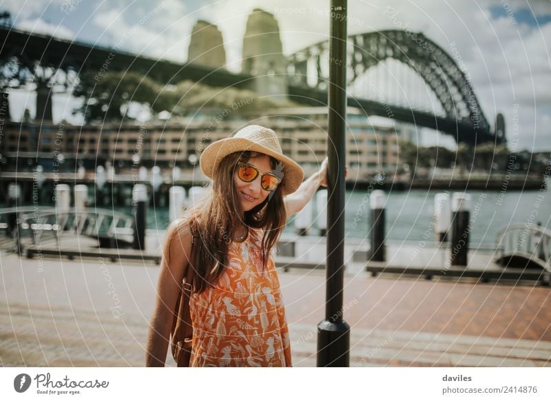 Cute girl with hat and sunglasses posing in Sydney city, with Harbour Bridge in the background, Australia. Lifestyle Vacation & Travel Trip City trip