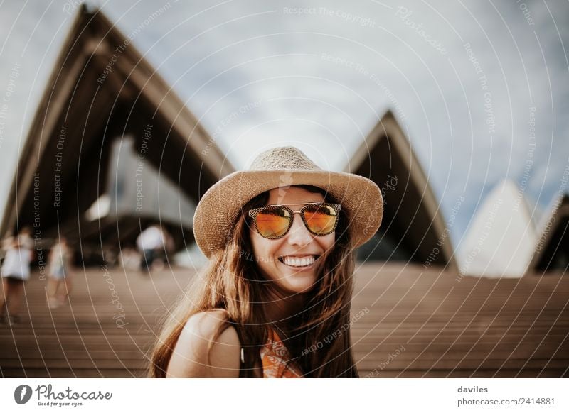 Lovely woman with hat and sunglasses looking at camera, while visiting Sydney Opera House, Australia. Lifestyle Joy Vacation & Travel Tourism City trip Summer