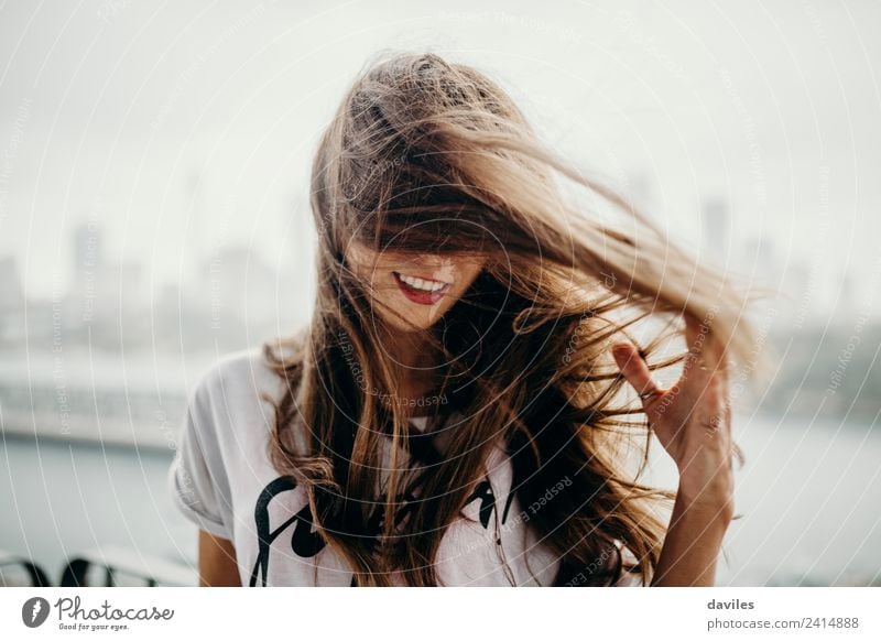 Cute woman touching her hair while the wind moves it. Lifestyle Freedom Summer Human being Woman Adults Hair and hairstyles 1 18 - 30 years Youth (Young adults)