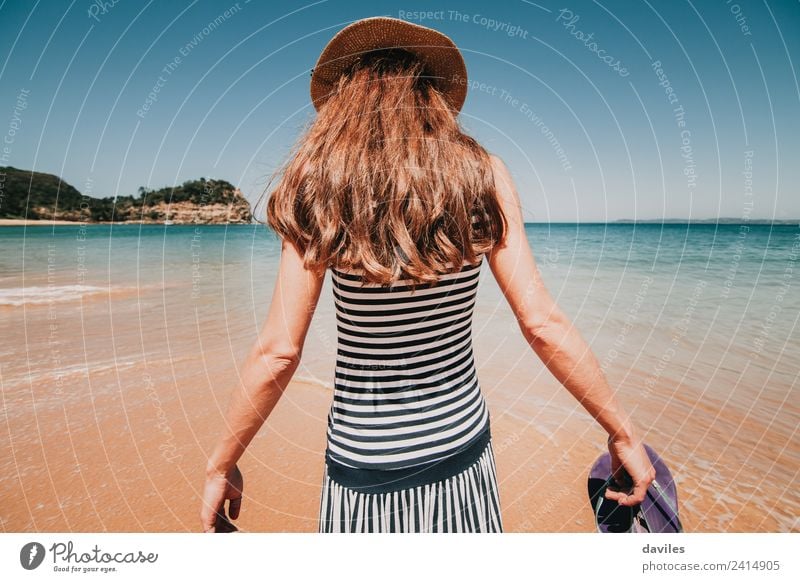 Blonde woman in her back walking by the beach sand into the water Lifestyle Well-being Vacation & Travel Tourism Adventure Summer Beach Ocean Human being Woman