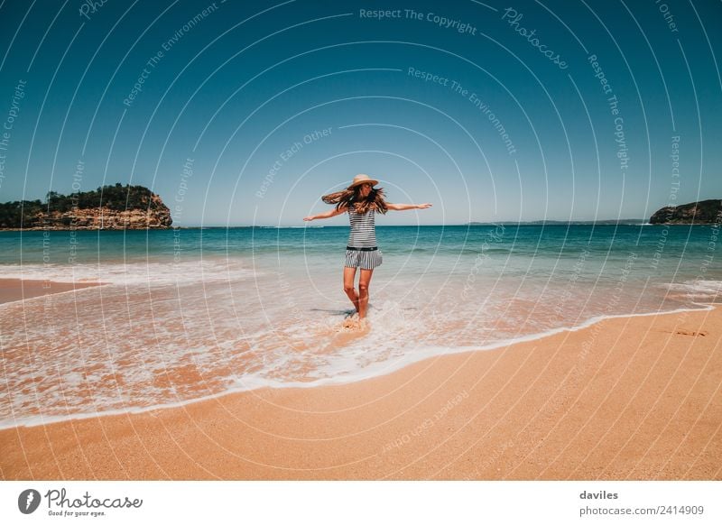 Woman with a hat and a dress dancing in the beach water in a beautiful Australian beach. Lifestyle Joy Wellness Well-being Freedom Adults 1 Human being