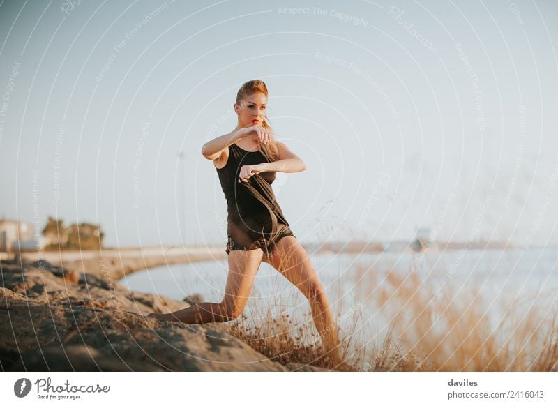Blonde white woman performing contemporary dance at the sea shore. Lifestyle Joy Athletic Fitness Sports Training Human being Feminine Young woman