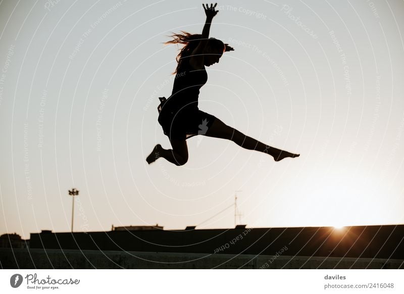 Woman silhouette while jumping in the air during dance performing. Beautiful Freedom Dance Sports Human being Feminine Young woman Youth (Young adults) Adults 1