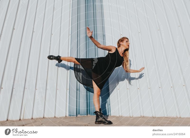 Blonde woman in black dress dancing while raises a leg up. Lifestyle Body Dance Sports Human being Feminine Woman Adults Youth (Young adults) Arm 1