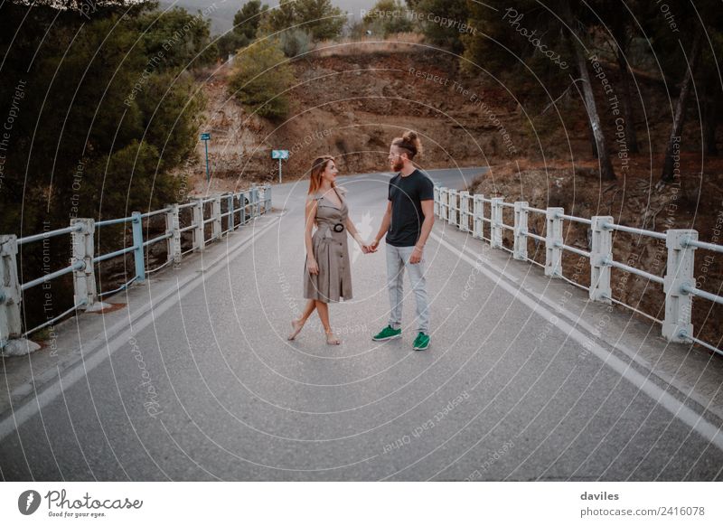 Coupole holding hands standing on a road Lifestyle Style Joy Happy Beautiful Leisure and hobbies Trip Summer Dance Woman Adults Man Couple Partner 2 Human being