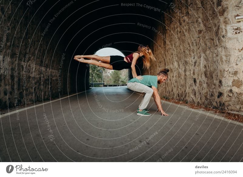 Couple dancing in the middle of the road, inside a tunnel. Lifestyle Style Beautiful Sports Woman Adults Man 2 Human being 18 - 30 years Youth (Young adults)