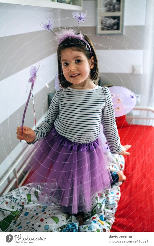 Little girl playing disguised as butterfly on bed Lifestyle Joy Beautiful Playing Bedroom Child Human being Woman Adults Infancy Antenna Skirt Butterfly Wing