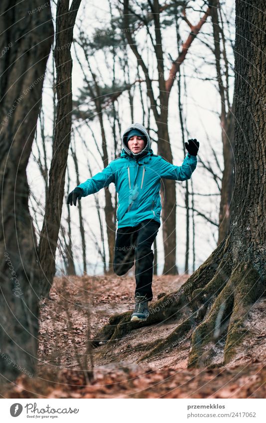 Young man running outdoors during workout in a forest Lifestyle Relaxation Leisure and hobbies Winter Sports Fitness Sports Training Jogging Human being