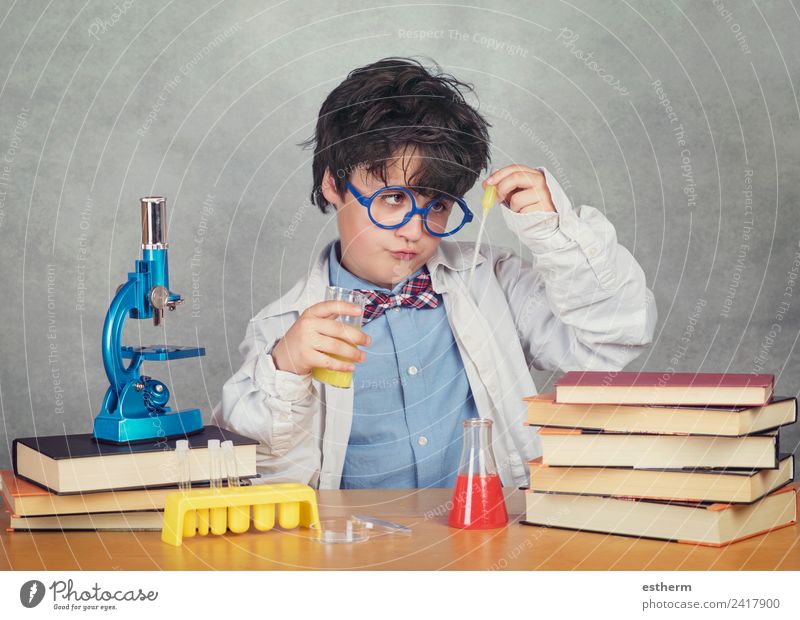 boy is making science experiments in a laboratory Lifestyle Education Science & Research Child Study Schoolchild Laboratory Human being Masculine Toddler