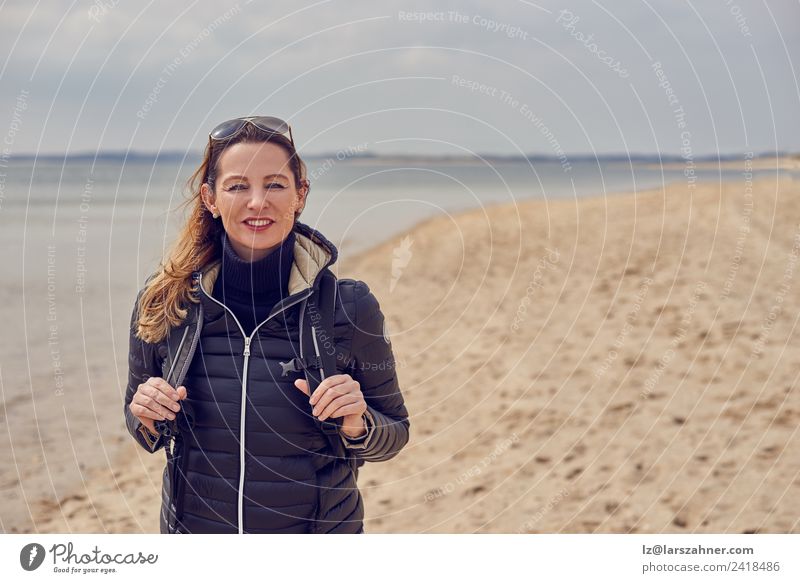 Pretty healthy woman enjoying a hike on a beach Happy Leisure and hobbies Beach Hiking Woman Adults 1 Human being 45 - 60 years Clouds Spring Autumn Coast