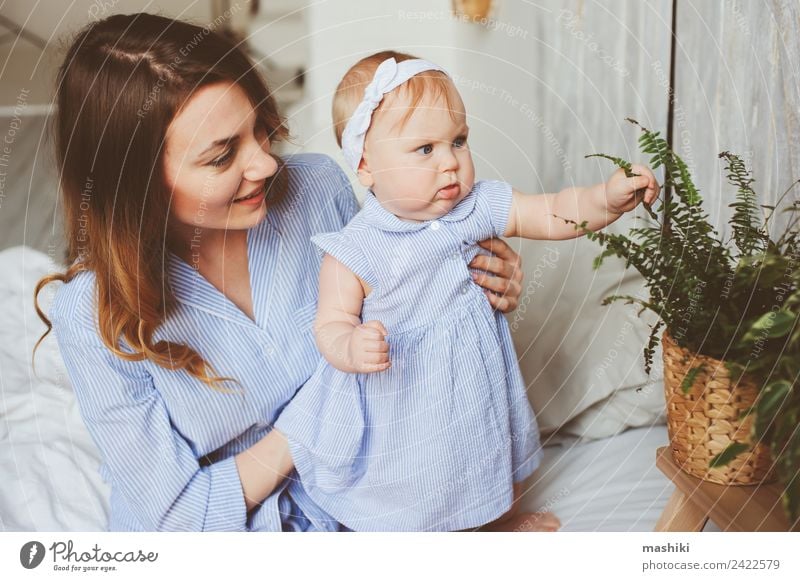 happy mother and 9 month old baby in matching pajamas Lifestyle Joy Playing Bedroom Baby Parents Adults Mother Family & Relations Infancy Hand Embrace Happiness