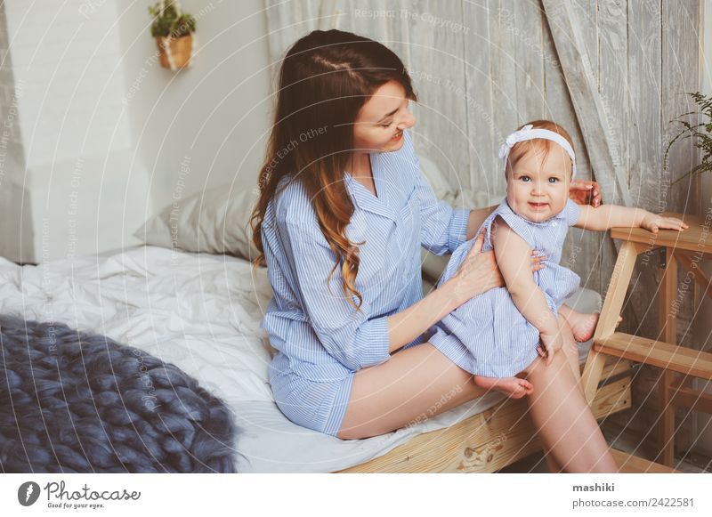 happy mother and 9 month old baby in matching pajamas Lifestyle Joy Happy Playing Bedroom Baby Parents Adults Mother Family & Relations Infancy Hand Stripe