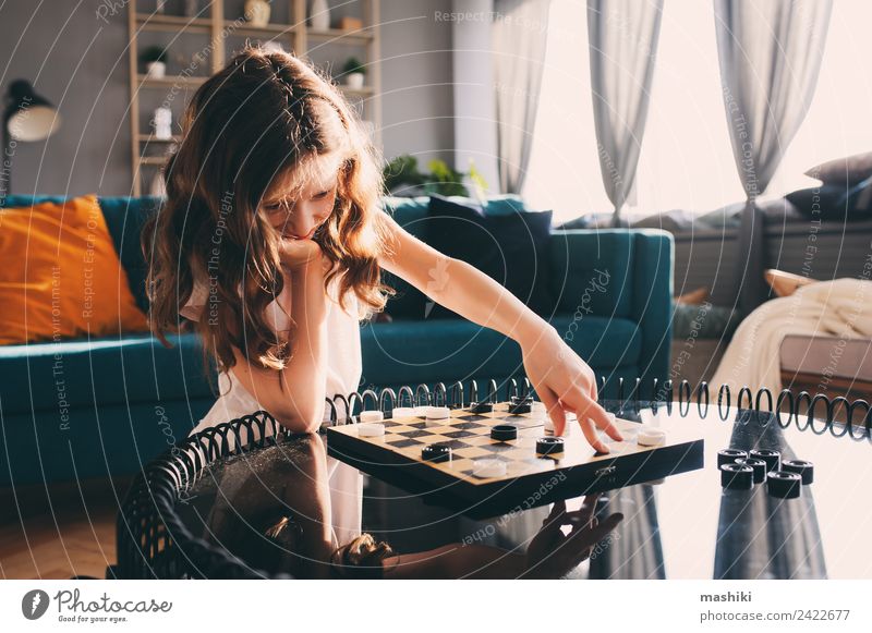 lifestyle shot of smart kid girl playing checkers at home Lifestyle Leisure and hobbies Playing Chess Child Girl Parents Adults Family & Relations Toys Think