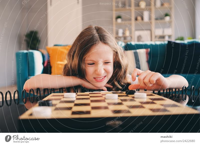 lifestyle shot of smart kid girl playing checkers at home Lifestyle Leisure and hobbies Playing Chess Success Child Girl Family & Relations Infancy Toys Think