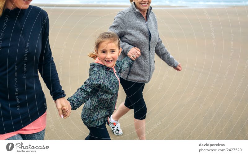 Little girl running with women on beach Lifestyle Joy Happy Playing Beach Child Human being Woman Adults Mother Grandmother Family & Relations Sand Autumn Fog