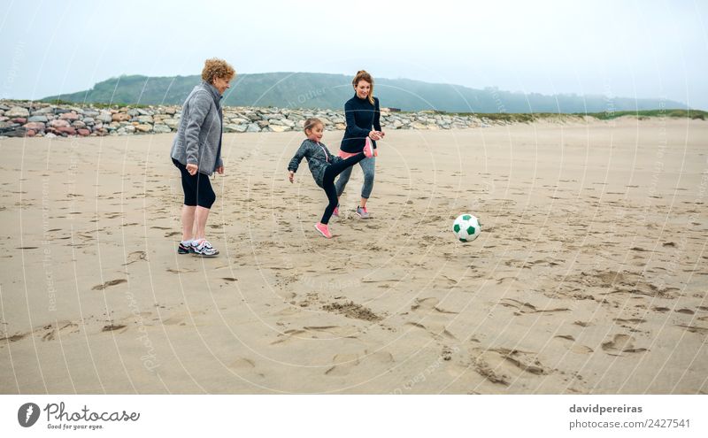 Three generations female playing soccer on the beach Lifestyle Joy Happy Playing Beach Child Human being Woman Adults Mother Grandmother Family & Relations Sand