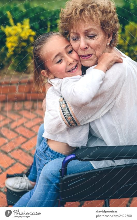Granddaughter hugging her grandmother Lifestyle Happy Health care Relaxation Garden Human being Woman Adults Grandmother Family & Relations Nature Plant Tree