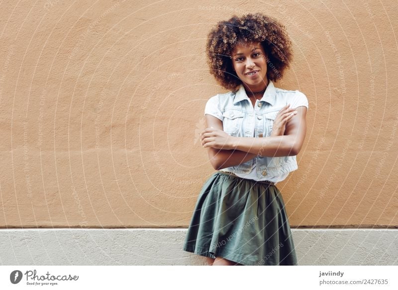 Young black woman, afro hairstyle, smiling near a wall in the street Lifestyle Style Happy Beautiful Hair and hairstyles Face Human being Young woman