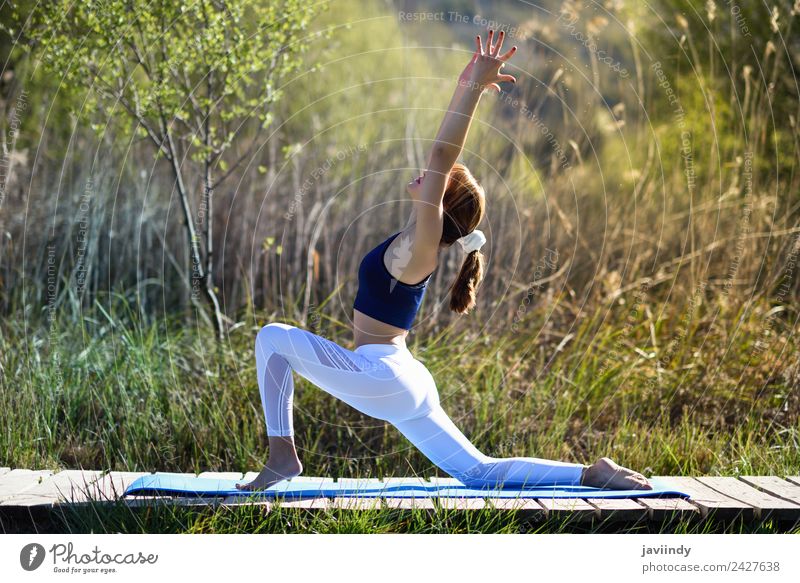 Young beautiful women practicing yoga outdoors - a Royalty Free Stock Photo  from Photocase