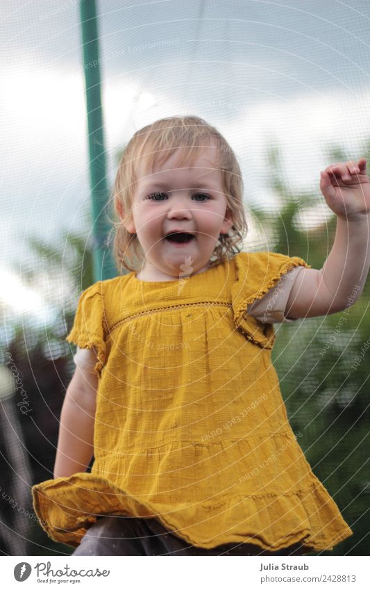 girl toddler to dance dress Bushes Dress Blonde Movement Jump Dance Romp Small Funny Yellow Black Moody Joie de vivre (Vitality) Colour photo Exterior shot Day