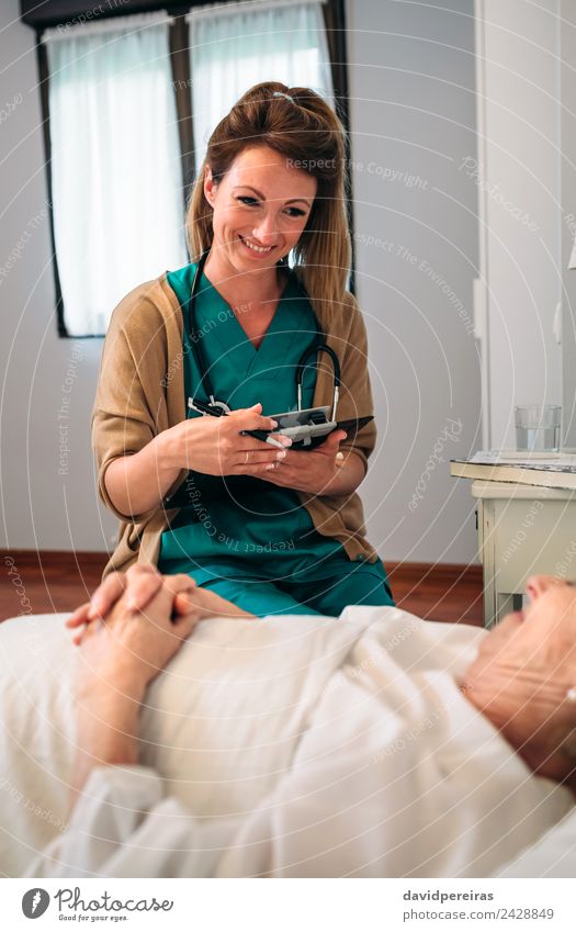 Female doctor comforting older patient Illness Medication House (Residential Structure) Doctor Hospital To talk Human being Woman Adults Old Smiling Authentic