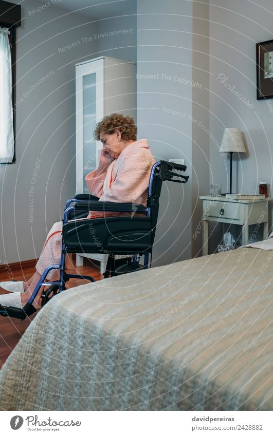 Senior woman in a wheelchair alone in a room Lifestyle Health care Illness Medication Relaxation Lamp Hospital Retirement Human being Woman Adults Old Sit