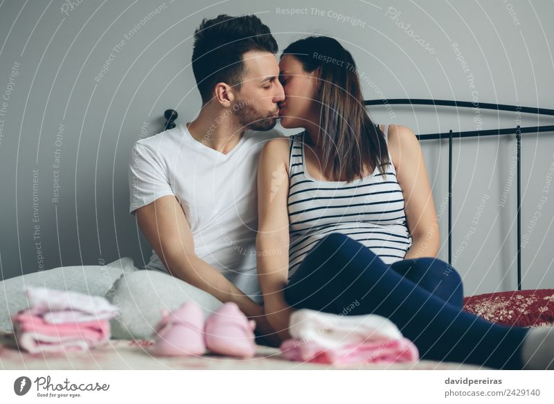 Man kissing his pregnant wife Beautiful Human being Baby Woman Adults Mother Family & Relations Couple Clothing Footwear Beard Kissing Love Sit Authentic