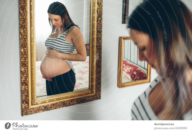 Pregnant woman looking her belly Lifestyle Beautiful Mirror Bedroom Human being Baby Woman Adults Parents Mother Hand Think Love Growth Wait Authentic Naked
