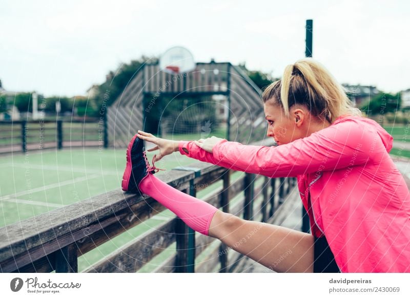 Young woman stretching legs before training outdoors Lifestyle Sports Jogging Racecourse Human being Woman Adults Arm Park Street Sneakers Blonde Braids Line
