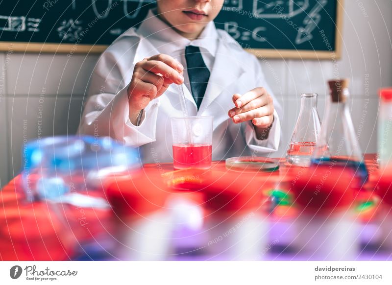 Kid playing to be chemist with colorful liquids Bottle Spoon Playing Flat (apartment) Table Science & Research Child Classroom Laboratory Human being