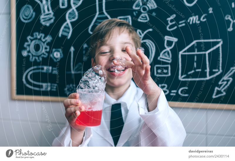 Happy hid holding glass with soap foam Joy Playing Flat (apartment) Science & Research Child School Classroom Blackboard Laboratory Human being Boy (child)