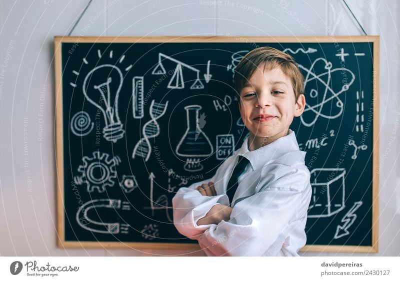 Smiling kid looking at camera in front of blackboard Happy Playing Flat (apartment) Science & Research Child Classroom Blackboard Laboratory Human being