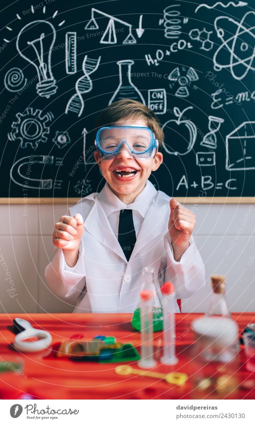 Little scientist laughing behind of table with experiment elements Bottle Happy Playing Flat (apartment) Table Science & Research Child School Classroom
