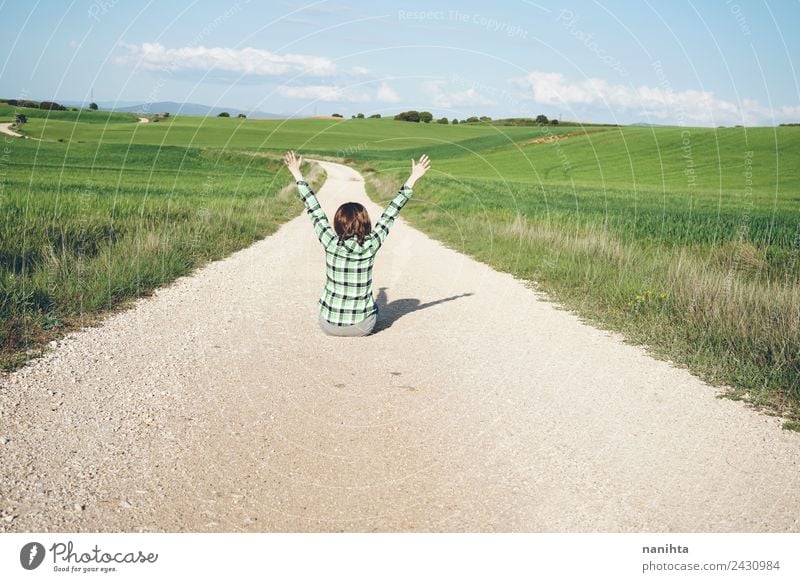 Young woman with her arms raised in a rural path Lifestyle Design Wellness Harmonious Well-being Vacation & Travel Adventure Freedom Summer Summer vacation Sun