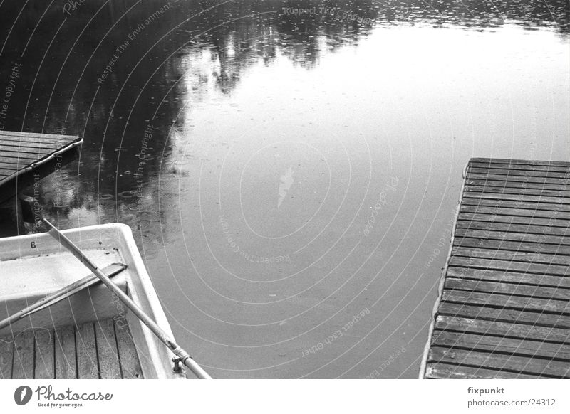 1632-025 Lake Rain Footbridge Watercraft Dreary Black & white photo