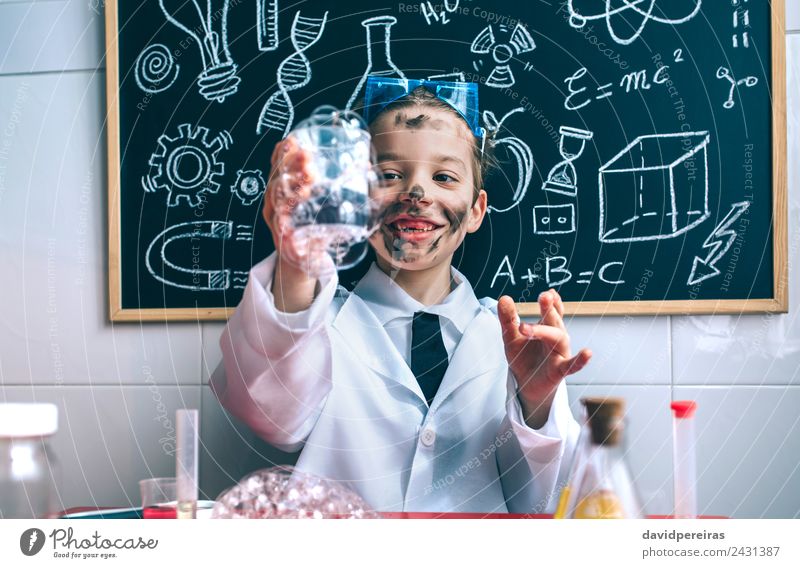 Little boy scientist holding glass with soap foam against of blackboard Happy Face Playing Flat (apartment) Table Science & Research Child School Classroom