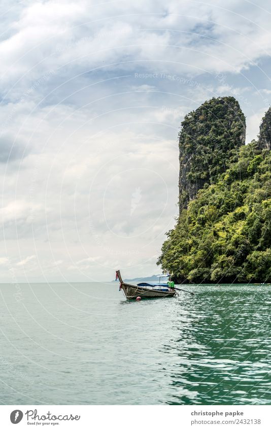 Longtail boat in front of rocks in Thailand Calm Vacation & Travel Tourism Trip Adventure Far-off places Summer Summer vacation Ocean Island Waves Environment