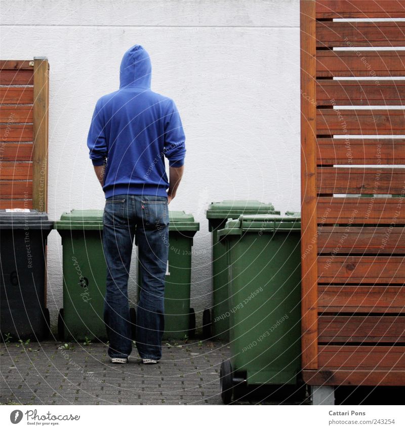 He just took the garbage outside. Masculine 1 Human being Wall (barrier) Wall (building) Jeans Sweater Cloth Cap Select Utilize Stand Nerdy Thin Trashy Blue