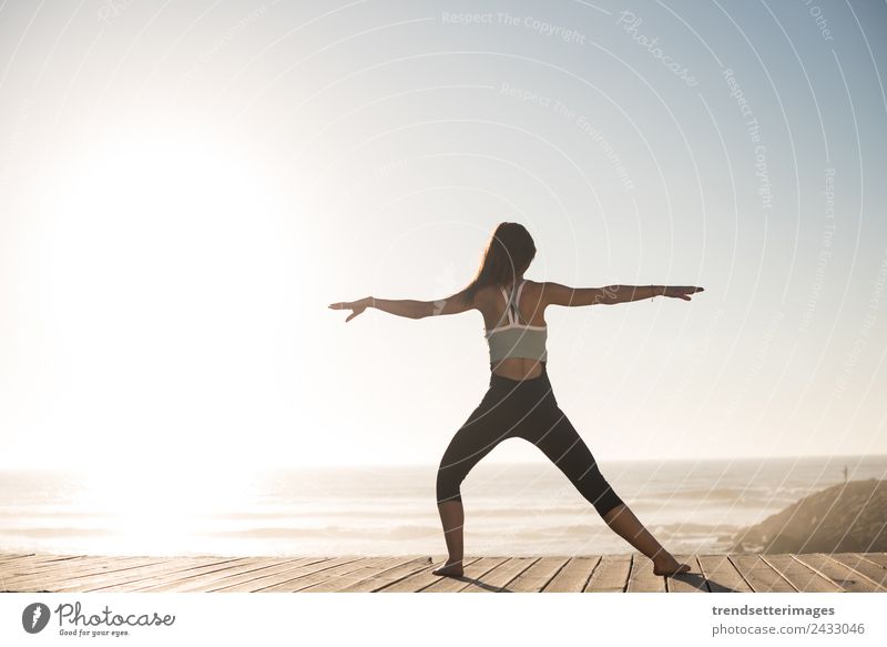 Women doing pilates on the beach - a Royalty Free Stock Photo from Photocase