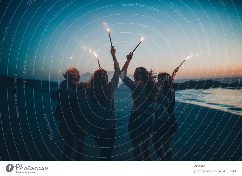 Happy group of girlfriends celebrating at beach with sparklers Lifestyle Joy Beautiful Summer Sun Beach Ocean Woman Adults Friendship Nature Sand Coast Blonde