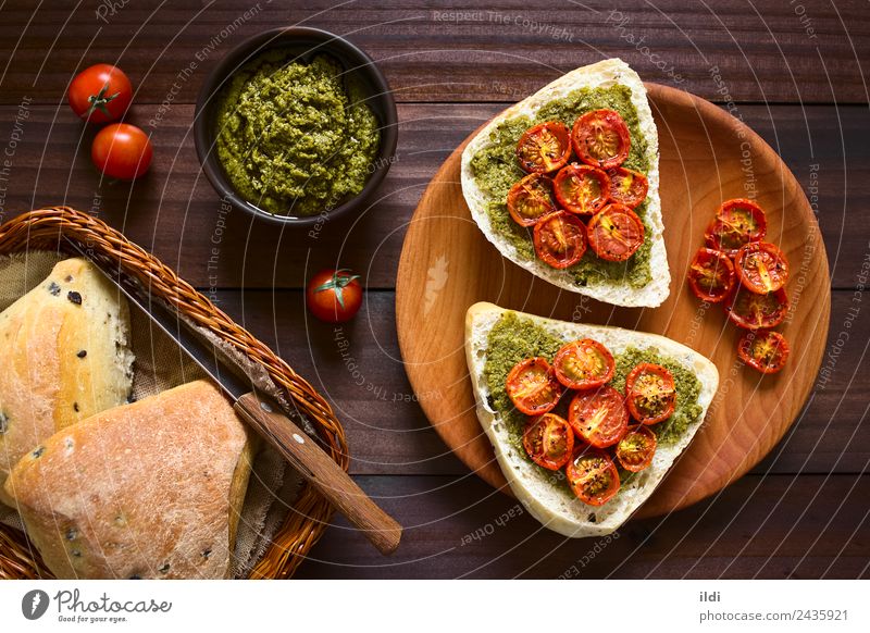 Bread Roll with Pesto and Roasted Tomato Vegetable Breakfast Vegetarian diet Fresh food olive pesto roasted topping Spread Sauce Basil pepper Snack brunch