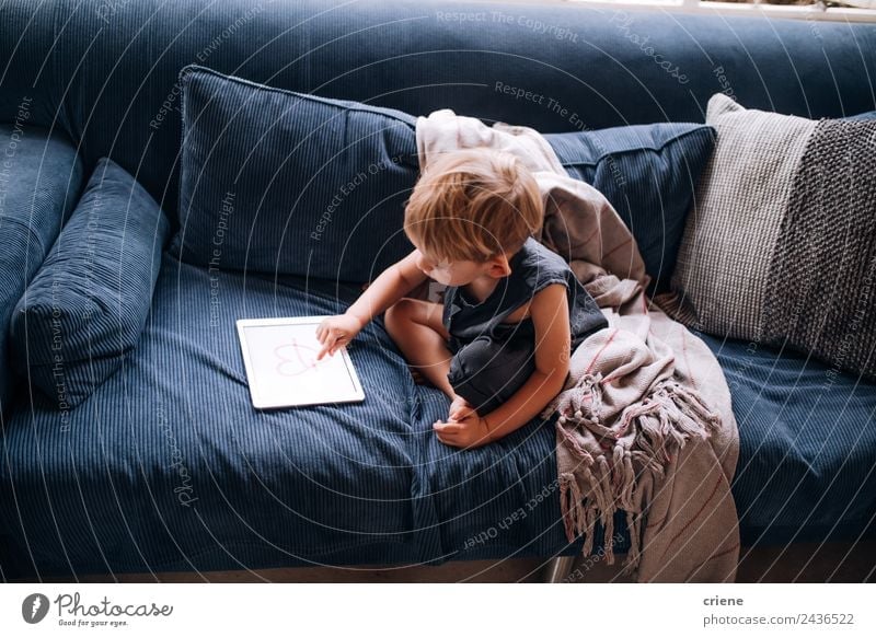 young caucasian little boy playing with tablet on couch Joy Beautiful Playing Sofa Living room Child Computer Screen Technology Toddler Boy (child) Infancy