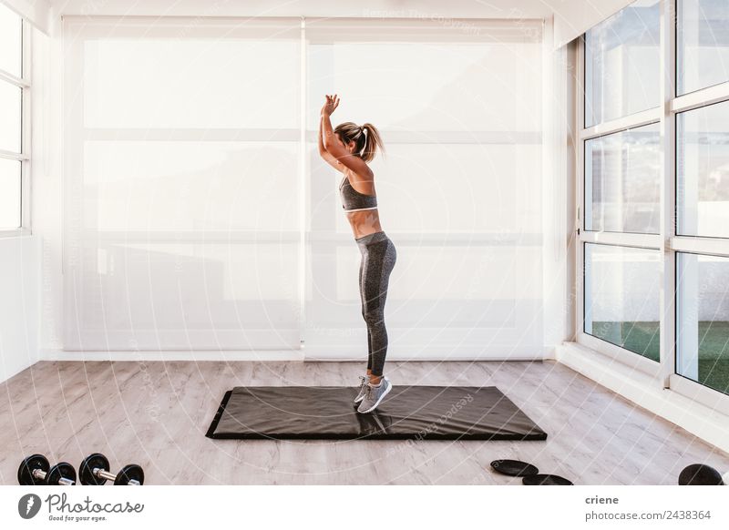 young caucasian woman doing fitness on mat at home Lifestyle Style Beautiful Body Wellness House (Residential Structure) Sports Woman Adults Fitness Jump